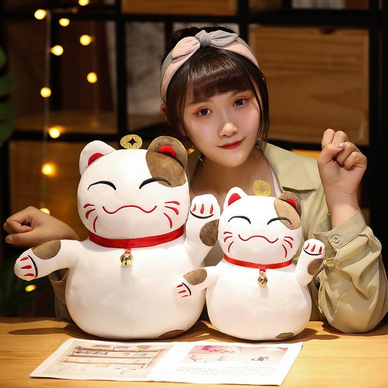 a lady with a plushie cat of a lucky cat