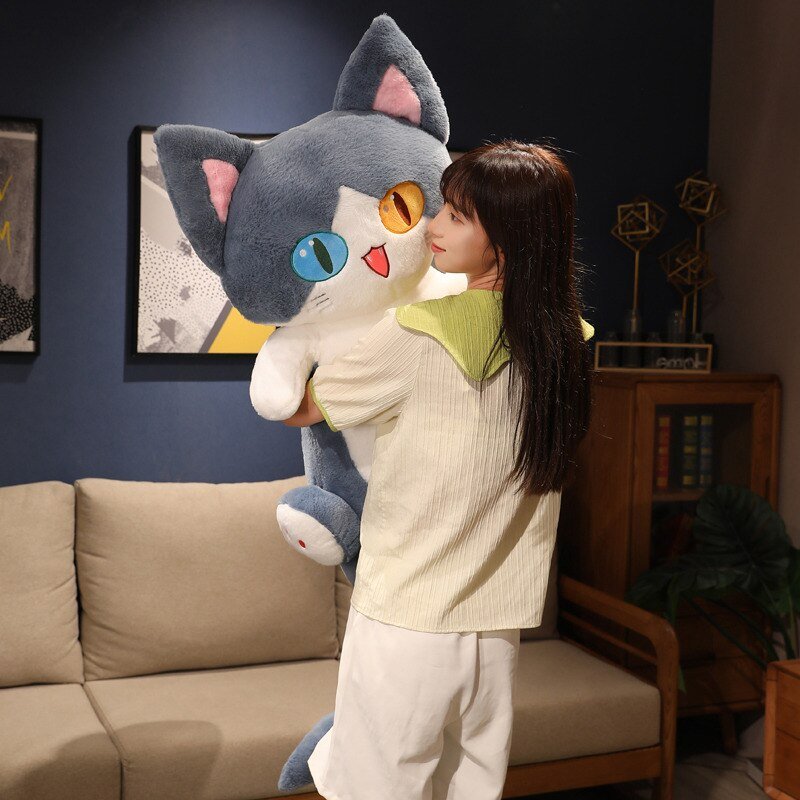 a lady hugging a giant cat plush of a cat shark