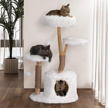 3 cats laying on a modern jungle cat tree with white color fluffy surface that looks like clouds