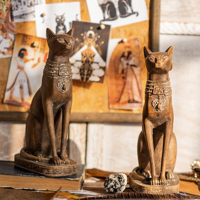 a pair of wooden style cat sculpture of egyptian cats