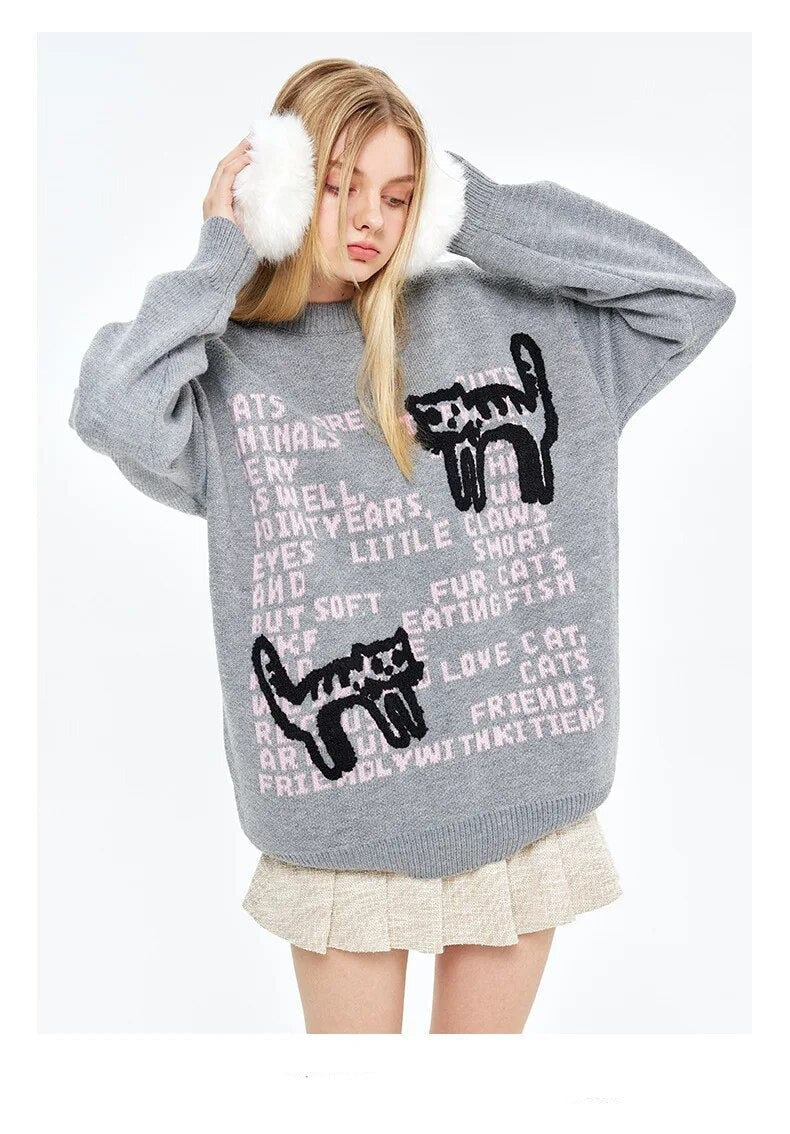 Two cats in stretching poses on Y2K themed sweatshirt