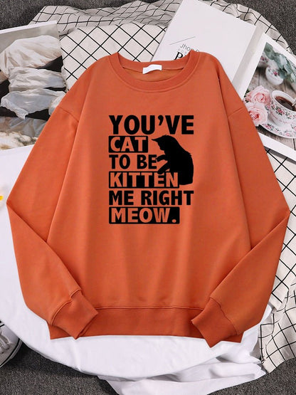an orange color sweatshirts with cats on them and funny pun